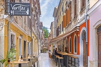 Narrow alley with restaurants in the historic town centre of the city Pula
