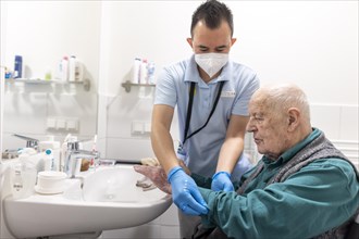 Caregiver and old man in a nursing home