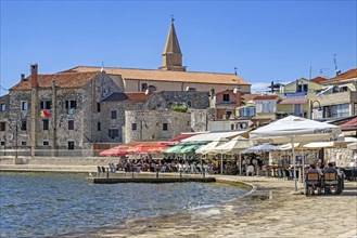 Terraces of restaurants along the waterfront in the town Umag