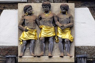 Three dark-skinned persons