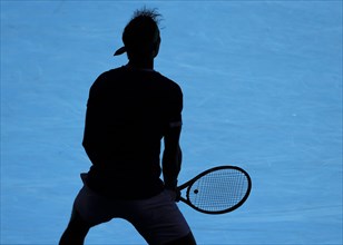 Silhouette of Spanish tennis player Rafael Nadal waiting to serve during the Australian Open 2022 tennis tournament