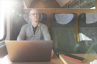 Man working in a Deutsche Bahn compartment car