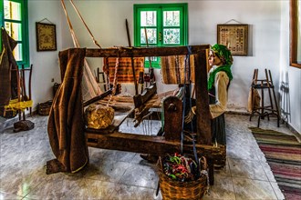 Loom in the local history museum with traditional clothing