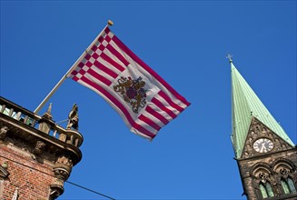 The Bremen Town Hall with a cathedral tower and the Bremen flag