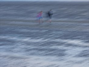 Two people in the mudflats
