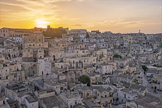 View over the Sassi di Matera complex of cave dwellings at sunset in the ancient town of Matera