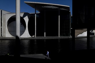 A person stands out at the Spreebogen in front of the Paul-Loebe-Haus at the Spreebogen in Berlin