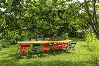 Table and colourful chairs in a garden