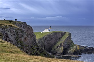 Walkers and the Stoer Head Lighthouse at the Point of Stoer in Sutherland