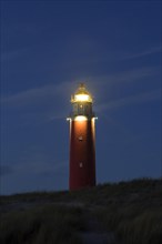 Eierland Lighthouse in the dunes at sunset on the northernmost tip of the Dutch island of Texel