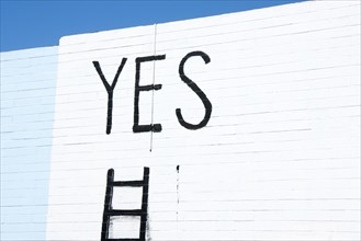 Word yes written on a wall