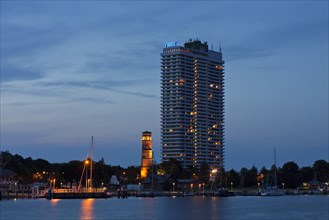 Maritim Hotel and the old lighthouse in the port of Travemuende at dusk