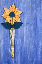 Fabric flower on blue background
