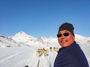 Inuit on dog sleds on Kong Oskar Fjord