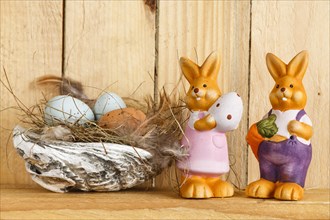 Easter Nest with 2 Easter Bunnies on the Wooden Background