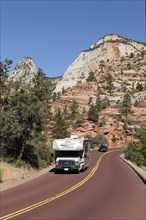 Motorhome driving on the panoramic Zion-Mt.Carmel Highway through bizarre rocky landscape