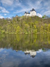 Burgk Castle reflected in the river Saale in spring