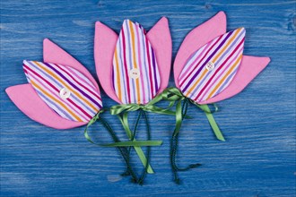 Three fabric tulips on a blue background