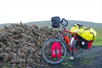 Dried peat sods and packed touring bike