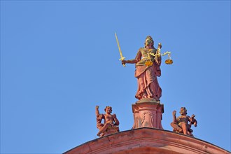 Justitia with golden beam scale at the town hall