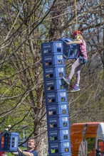 Child secured by rope falls while building tower out of beer crates