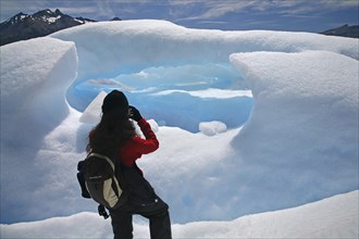 Tourist taking pictures of the Perito Moreno glacier in the Los Glaciares National Park