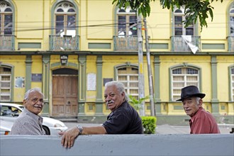 Costa Rican men on a bench in Parque Central