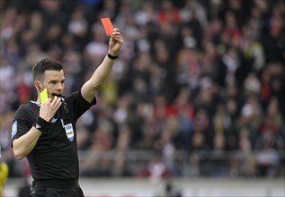 Referee Harm Osmers shows yellow-red card