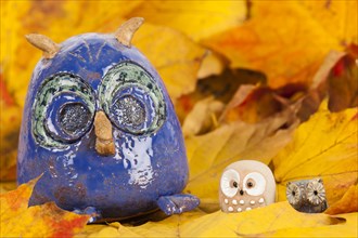 Owl figures on autumn leaves