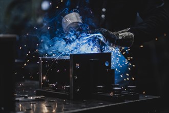 A metal worker welds metal