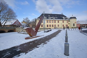 Winery building built 1720 with witch's tower and sculpture in winter with snow