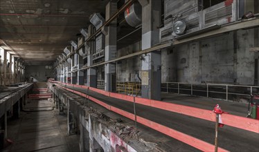 Security barrier in the empty production halls of a former paper factory