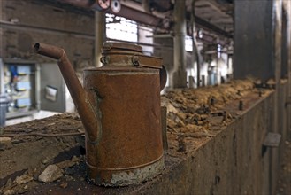 Rusty oil can in a former paper factory