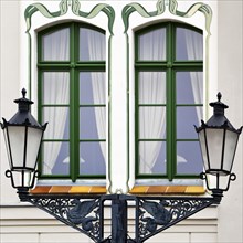 Old street lamps in front of facade with Jungendstil painting