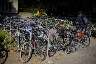Symbolic photo on the subject of parking spaces for bicycles. An overcrowded parking space for bicycles in front of the Hermsdorf S-Bahn station. Berlin