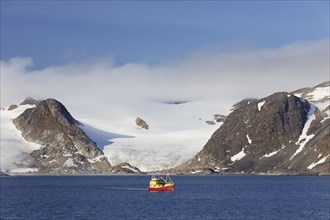 Fishing boat in the Hamilton Bay in front of mountains and glacier