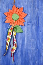 Fabric flower on blue background