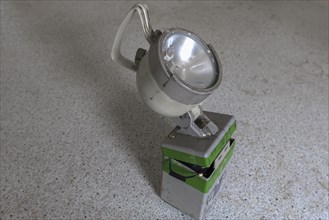 Handheld spotlight in an abandoned office of a former paper factory