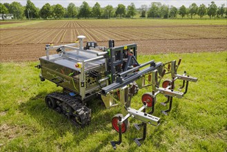 Autonomous agricultural robot with plough on an experimental field at the University of Hohenheim. Stuttgart