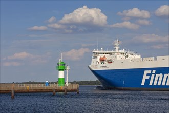 Ro-ro ferry Finnmill from Finnlines passing lighthouse Travemuende Nordmole