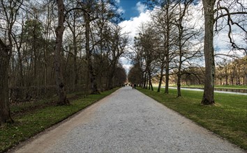 Avenue next to the palace garden canal in the park of Nymphenburg Palace