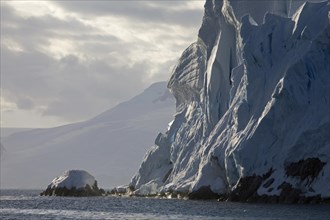 Crumbling wall of ice from glacier at Antarctica