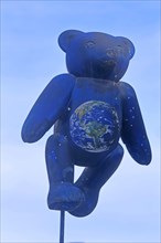 Blue bear figure and teddy bear with globe and symbol for Steiff company