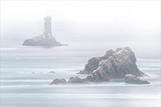 The lighthouse La Vieille in the strait Raz de Sein in thick fog