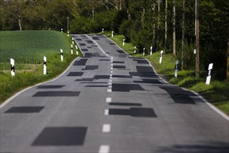 Repaired patches of road surface are seen on a country road in Brandenburg. Grossmutz