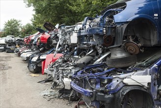 Crushed cars in scrap yard UK