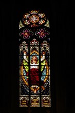 Stained glass window with Jesus at the blessing with biblical quote : I am the way and the truth and the life