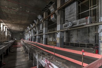 Security barrier in the empty production halls of a former paper factory