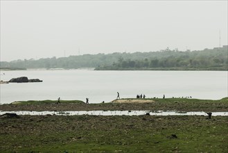 People silhouetted against the Niger River