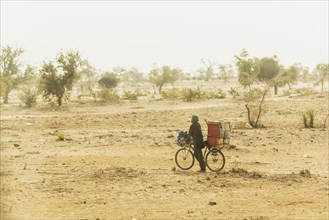 A cyclist runs through the desert